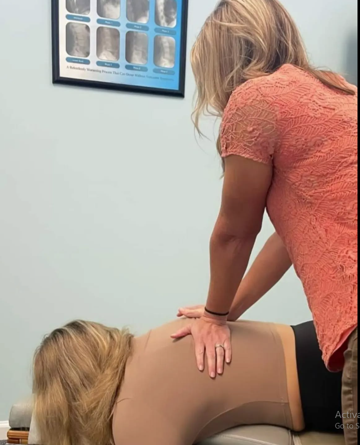 Dr. Nichole Quinn performing a chiropractic adjustment in North Charleston, SC